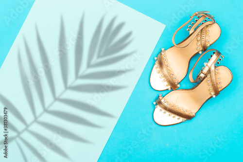 Elegant and stylish gold bridal shoes with leaf shadow