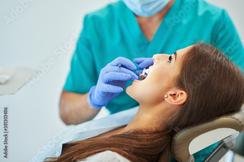 Male dentist and woman in dentist office