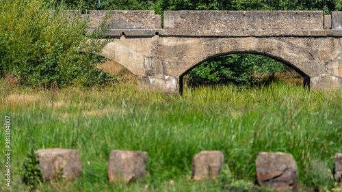 Antique stone bridge and stones over the river