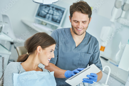 Male dentist and woman in dentist office