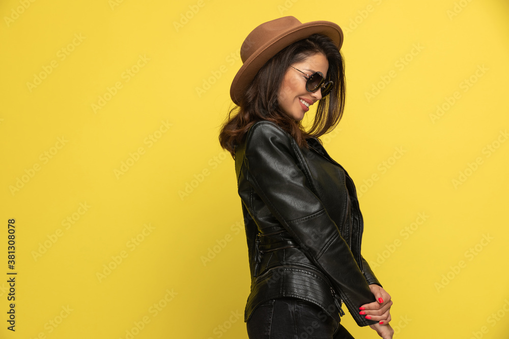 shy young girl in leather jacket holding hands shy young girl in leather jacket holding hands