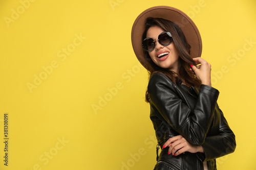 Photography sexy young woman in leather jacket looking to side and smiling