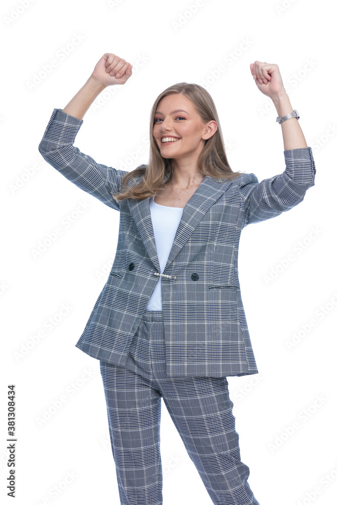 excited young woman holding fists in the air and smiling