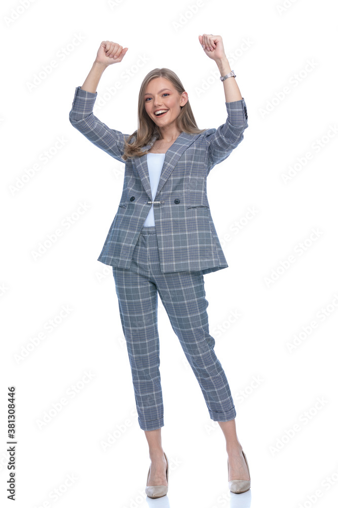 enthusiastic girl holding arms above head and cheering enthusiastic girl holding arms above head and cheering