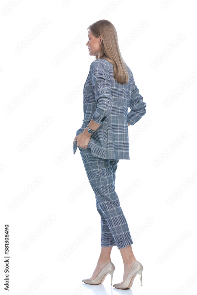 side view of young businesswoman holding hands in pockets side view of young businesswoman holding hands in pockets