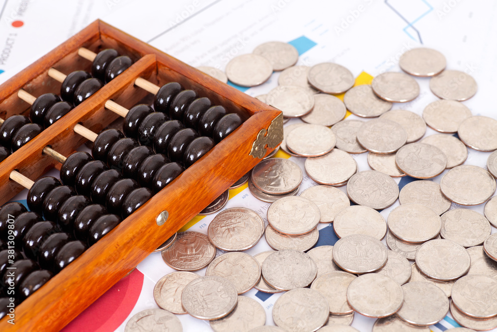 A lot of dollar coins and an abacus bead on financial documents A lot of dollar coins and an abacus bead on financial documents