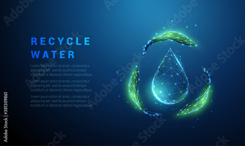 Falling drop of water with recycle symbol from green leafs photo