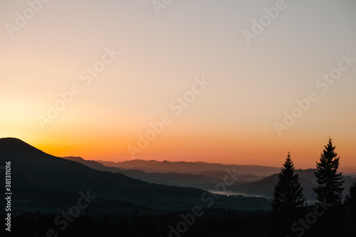Silhouette of mountains at sunset or sunrise.