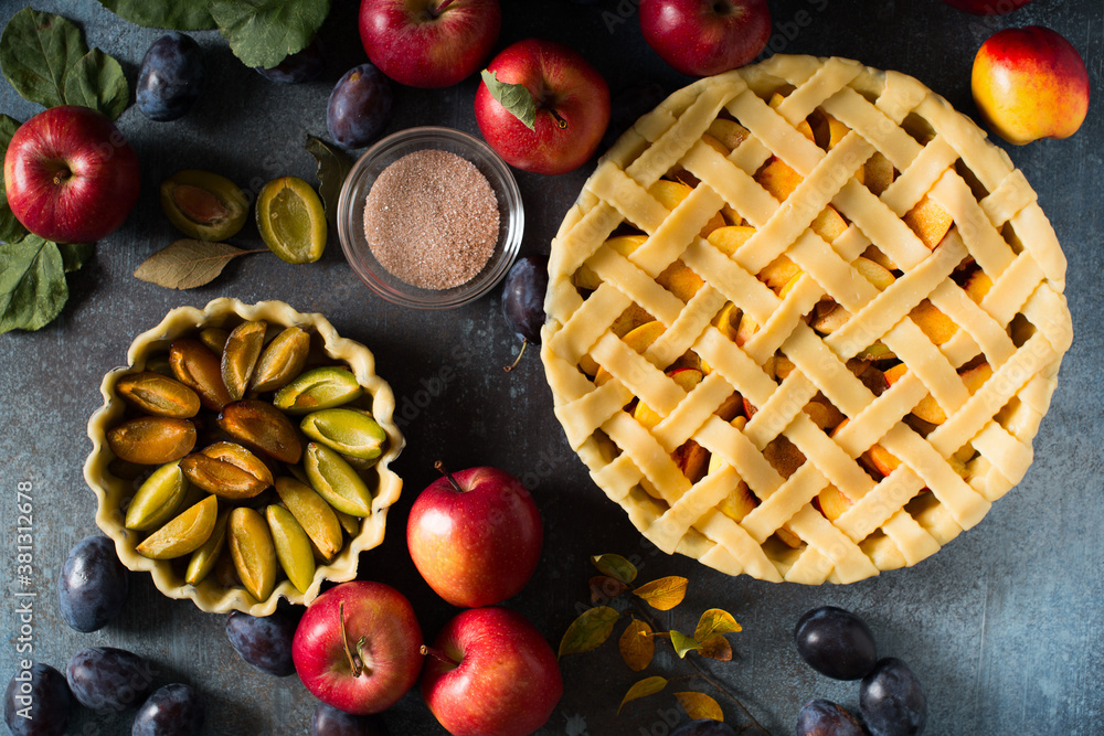Autumn and summer pie with apple and plum on dark background Autumn and summer pie with apple and plum on dark background