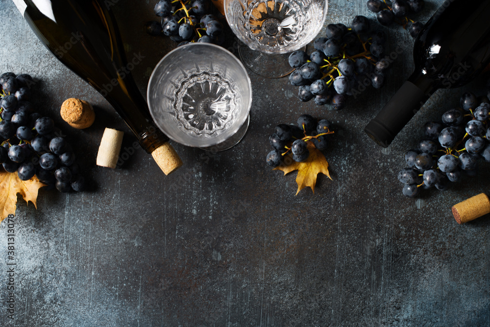 Bunche of black grape and bottle of wine on dark background Bunche of black grape and bottle of wine on dark background