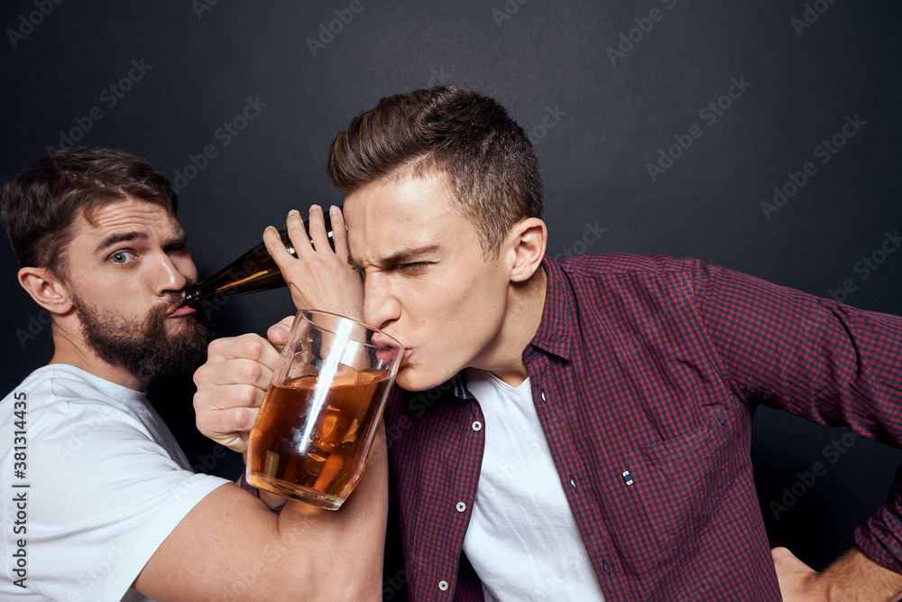 Two drunk friends drinking beer rest fun dark background Two drunk friends drinking beer rest fun dark background