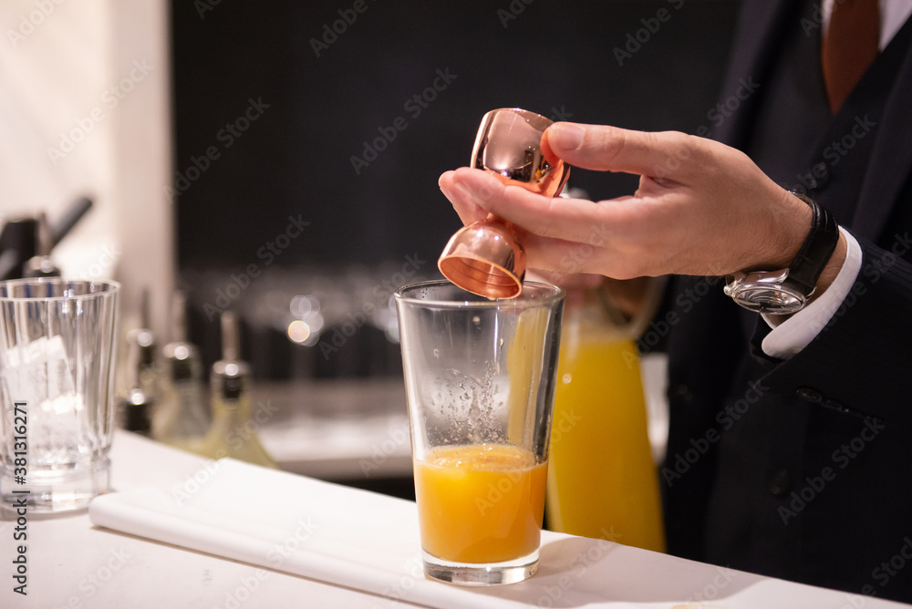 bartender making orange cocktail