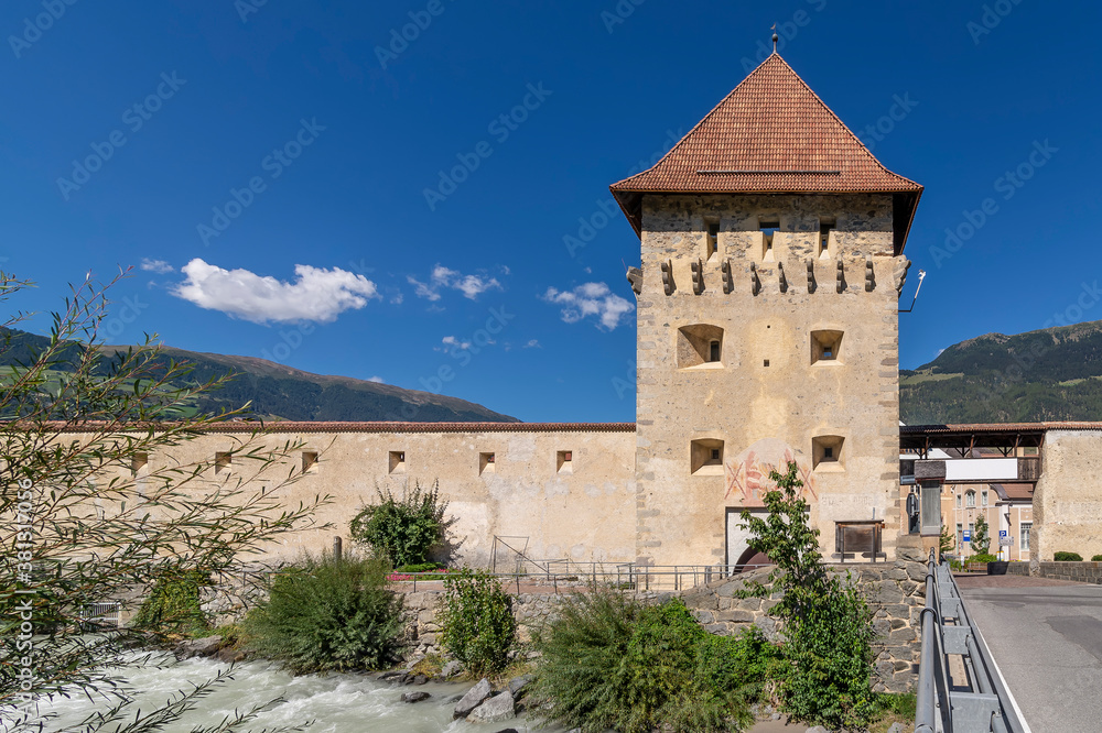 The Porta Tubre tower and the Adige River in Glorenza, South Tyrol, Italy, on a sunny day
