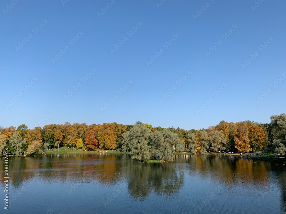 Golden trees on the lake in the fall time Golden trees on the lake in the fall time