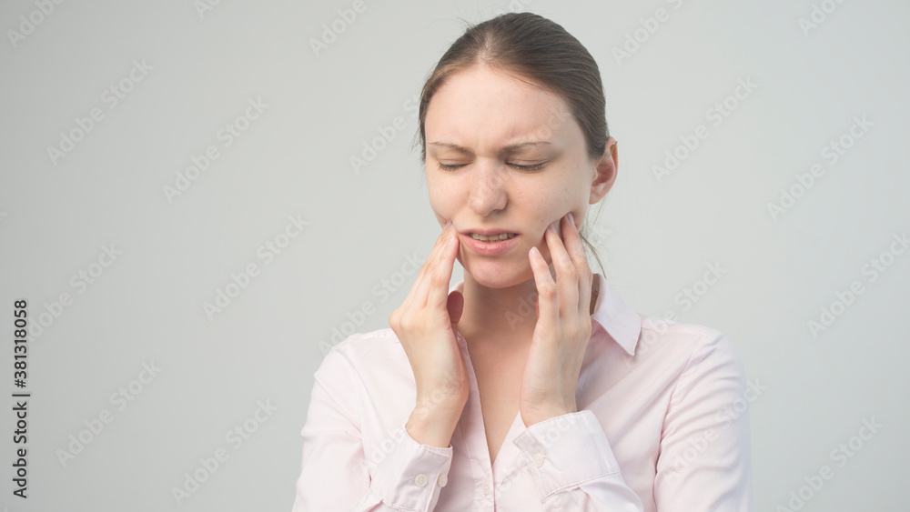 A tired woman feels pain in her teeth A tired woman feels pain in her teeth