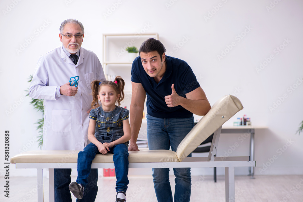 Young father and his daughter visiting old male doctor Young father and his daughter visiting old male doctor