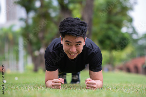 young man do planking  in the park photo