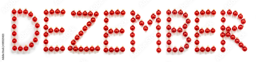 Red Christmas Ball Ornament Building German Word Dezember Means December. Festive Christmas Decoration. White Isolated Background Red Christmas Ball Ornament Building German Word Dezember Means December. Festive Christmas Decoration. White Isolated Background