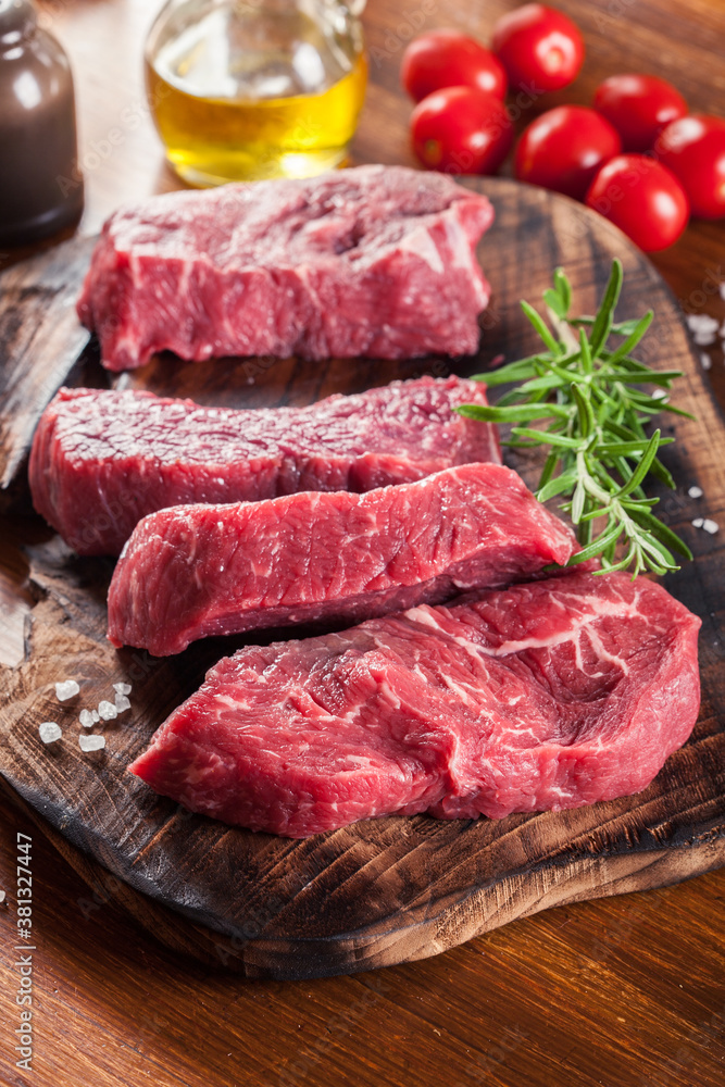 Raw beef steak on a cutting board Raw beef steak on a cutting board