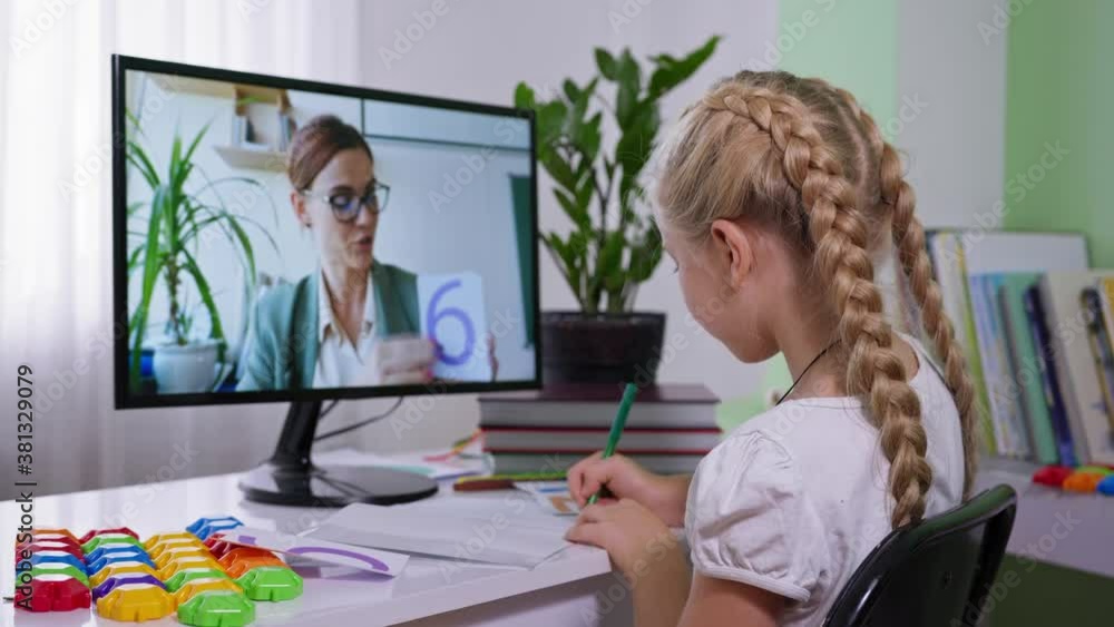 distance learning during a pandemic, schoolgirl studying mathematics with her female teacher sitting at home with computer distance learning during a pandemic, schoolgirl studying mathematics with her female teacher sitting at home with computer
