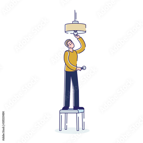 Man changing light bulb in ceiling lamp while standing on stool on white background