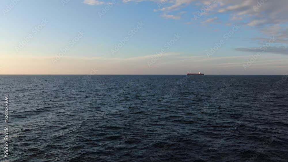 Large cargo ship. A bulk carrier carries cargo across the ocean. Transportation. Delivery. Logistics. A large ship for transporting. Aerial 4k shot. Large cargo ship. A bulk carrier carries cargo across the ocean. Transportation. Delivery. Logistics. A large ship for transporting. Aerial 4k shot.