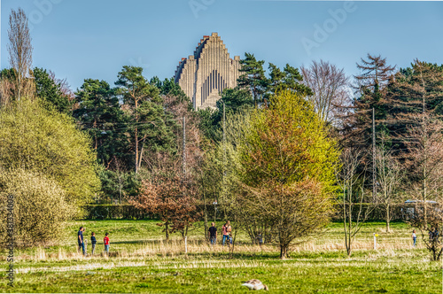Photography Church facade standing out of the trees in the Danish countryside