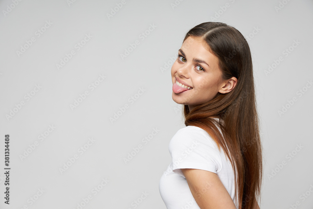 Cheerful woman showing tongue smile white t-shirt cropped view Cheerful woman showing tongue smile white t-shirt cropped view