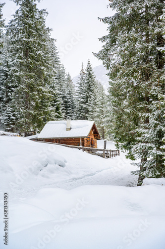 Wooden house in winter mountain landscape. Cottage / Hut in snowy mountains. Travel destination for recreation. © Simon Dannhauer
