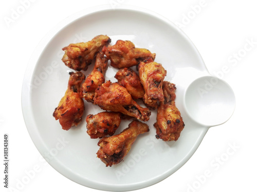 Fried chicken is a crispy and tasty on white dish isolate on white background.