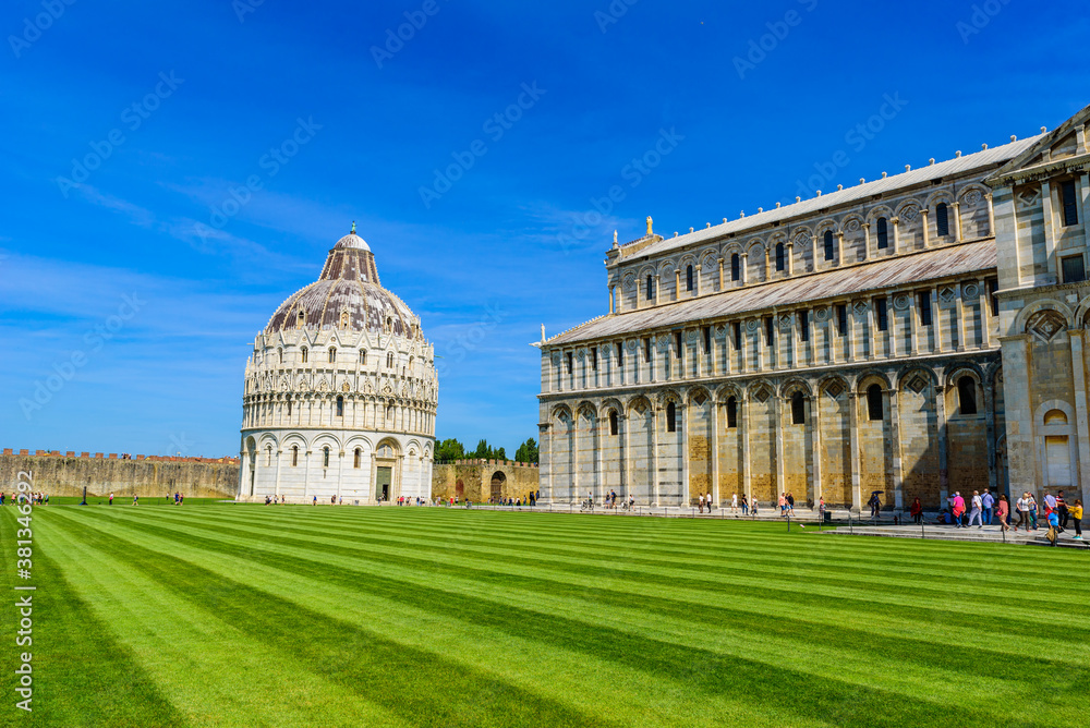 Pisa Cathedral (Duomo di Pisa) with Leaning Tower of Pisa on Piazza dei Miracoli in Pisa, Tuscany, Italy. World famous tourist attraction and travel destination.
