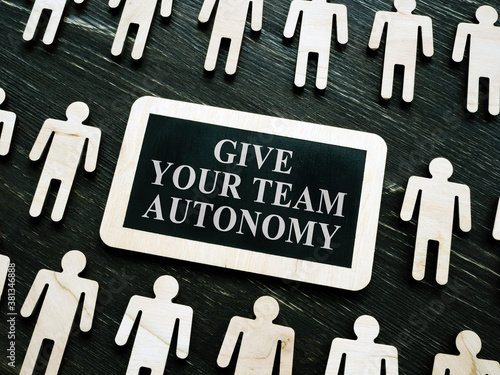 Giving your team autonomy quote and wooden figures.