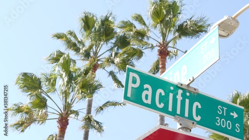 Pacific street road sign on crossroad, route 101 tourist destination, California, USA. Lettering on intersection signpost, symbol of summertime travel and vacations.Signboard in city near Los Angeles © Dogora Sun