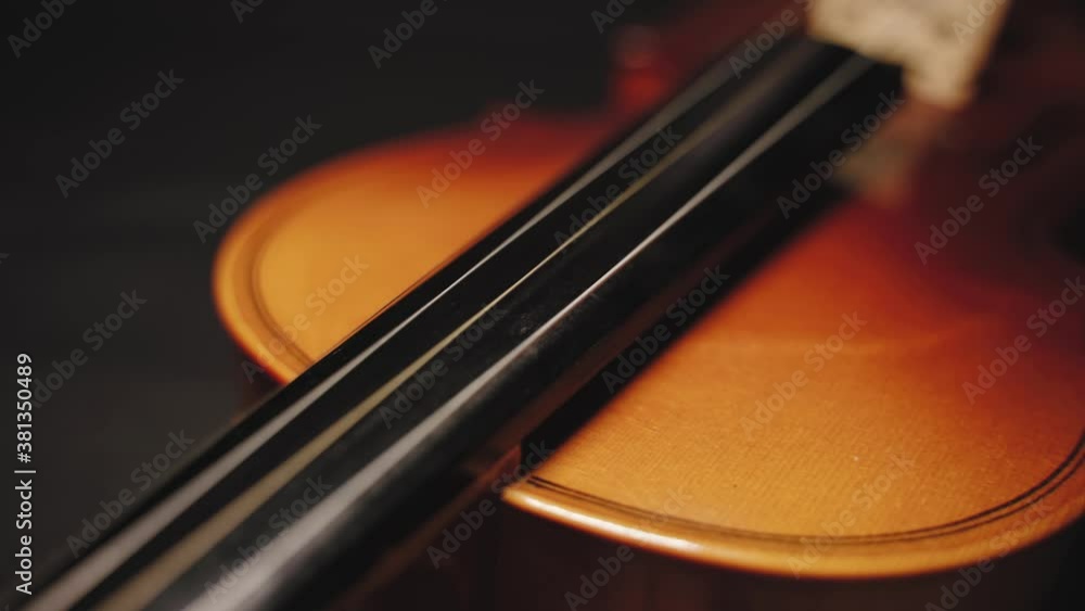 Close up forward dolly shot of antique violin isolated on dark background. Shallow DOF Close up forward dolly shot of antique violin isolated on dark background. Shallow DOF