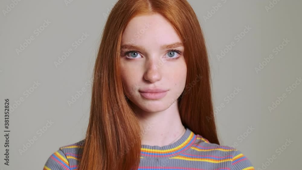 Young beautiful redhead happy woman posing isolated over white wall background Young beautiful redhead happy woman posing isolated over white wall background