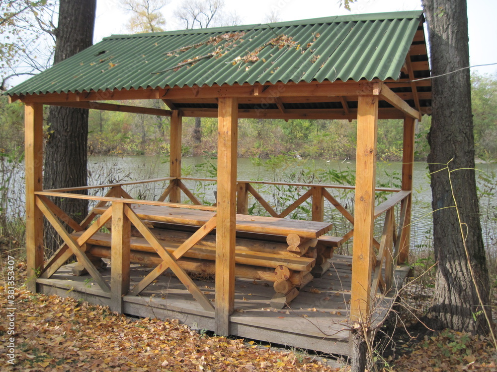 wooden house in the forest.Rest time in natural wooden bower on a sunny day in beautiful time of golden autumn. Relax with comfort in wild nature. wooden house in the forest.Rest time in natural wooden bower on a sunny day in beautiful time of golden autumn. Relax with comfort in wild nature.