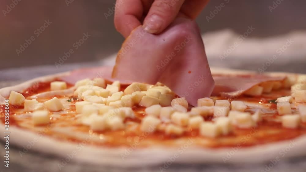 Close up view of a man chef cooking italian pizza. The process of making pizza at table in bakery. Fresh dough on kitchen table Close up view of a man chef cooking italian pizza. The process of making pizza at table in bakery. Fresh dough on kitchen table