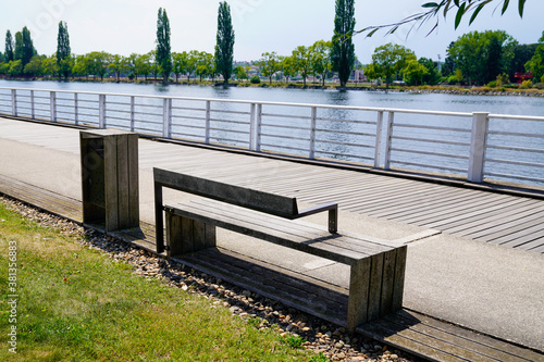 Fotografie Vichy city docks in Allier river with modern wooden bench in Auvergne France