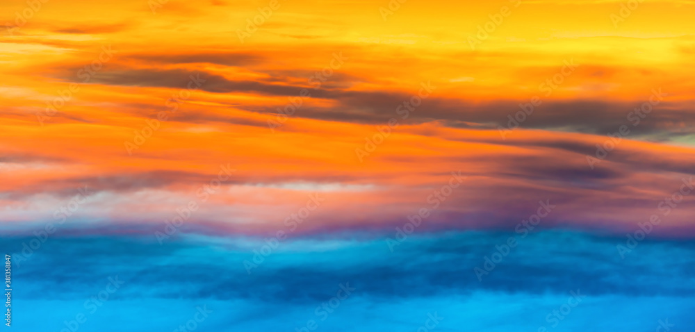 Sunset dramatic sky panorama with colorful clouds as nature sunset background