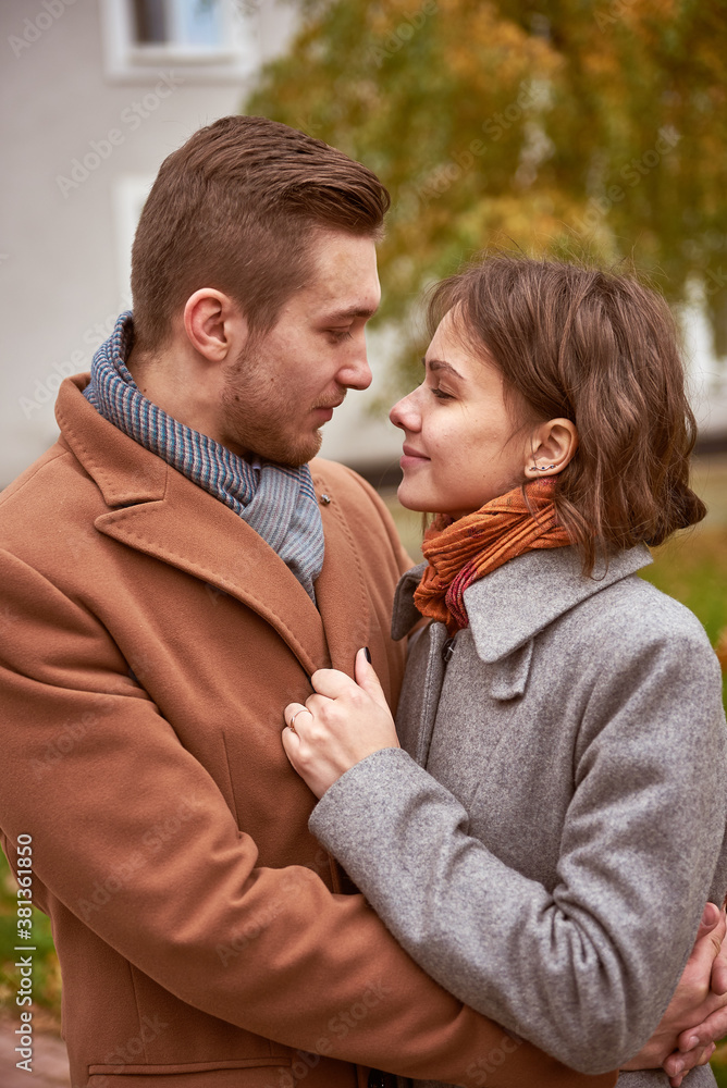 Young beautiful couple walking and hugging in the autumn park
Young beautiful couple walking and hugging in the autumn park