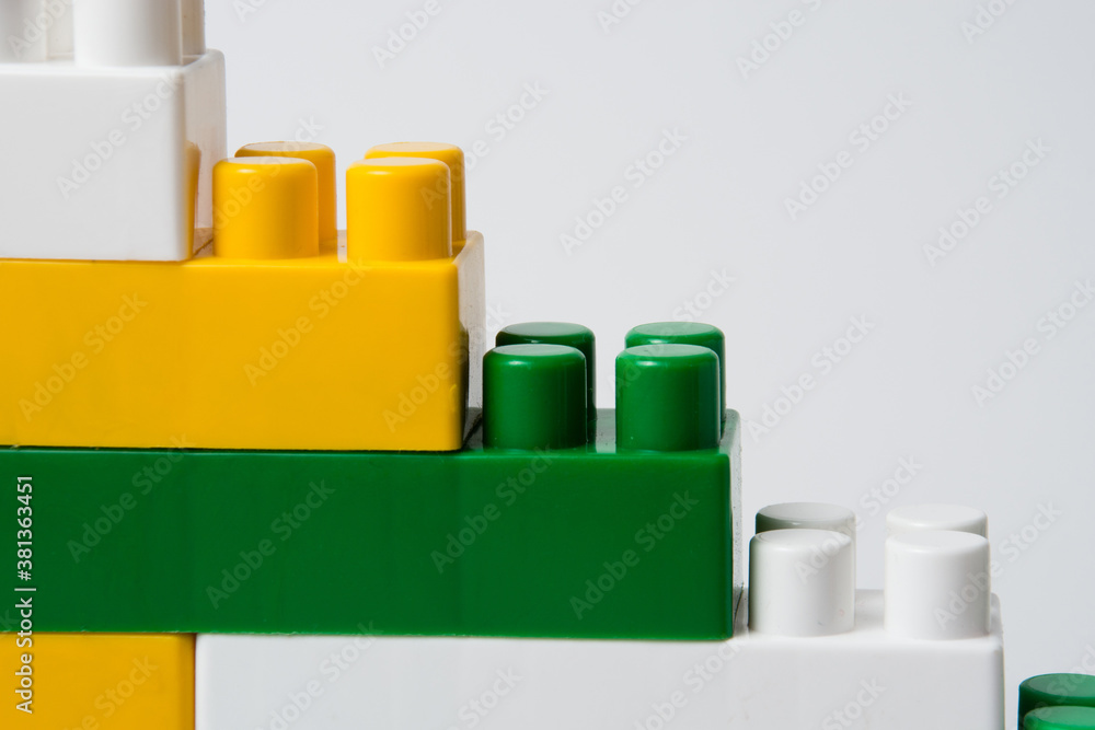 A pyramid made of colorful cubes of a children's constructor. Business, education and goals achievement concept.