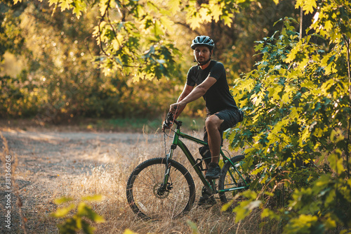 Bicycle rider in the forest, active lifestyle. Training in nature, fresh air.