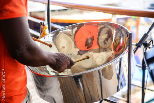 man is playing on a steel drums at cruise ship open deck photo