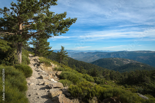 Trekking path on Guadarrama mountain range in a day with clouds and blue sky, Sierra de Guadarrama, Madrid, Spain
