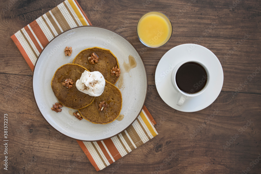 Pumpkin Pecan Pancakes with Syrup and Whipped Cream