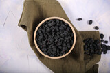 black Uzbek raisins lying on the table