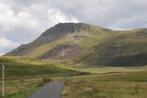 A single lane narrow mountain track up a long, remote valley beside Cadair Idris, Dolgellau, Gwynedd, Wales.