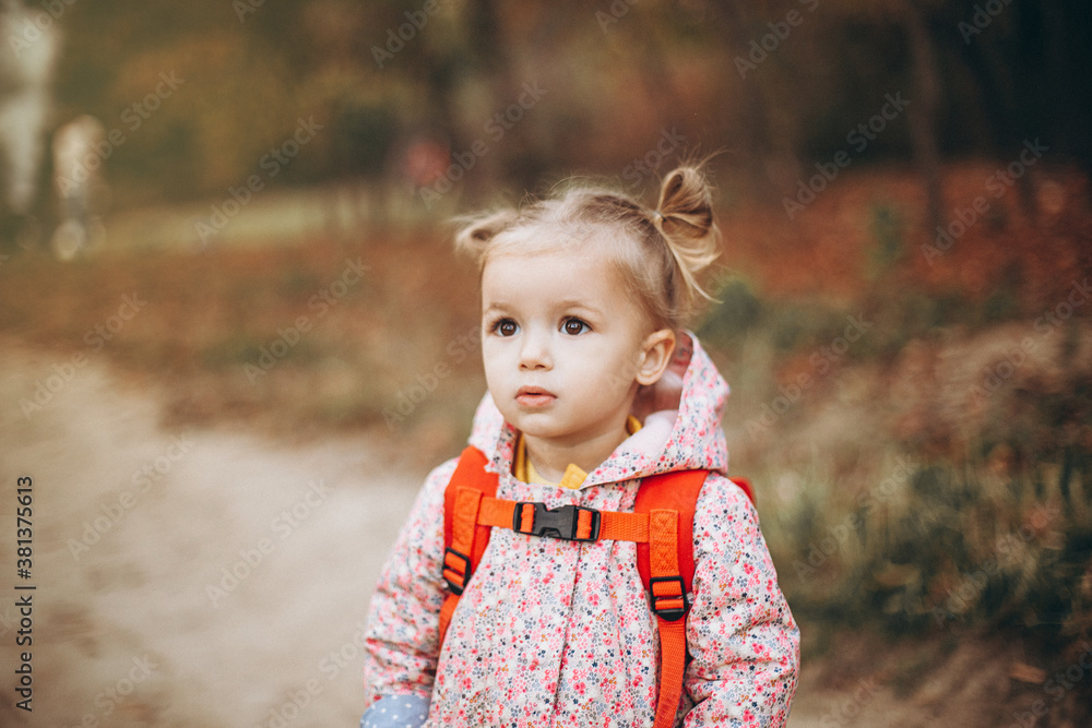little pretty girl posing for a photo while walking with her parents in autumn park, an infinitely happy and joyful child, selective focus, noise effect little pretty girl posing for a photo while walking with her parents in autumn park, an infinitely happy and joyful child, selective focus, noise effect