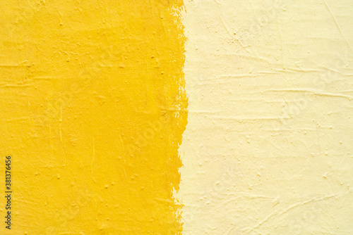 Yellow paint texture. Interior of a modern loft. Abstract bright background. The facade of an old house. Divided in half.