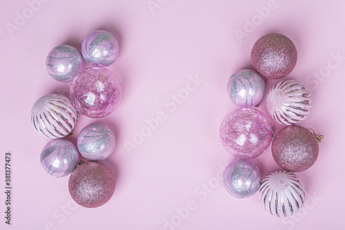 Christmas composition. Set of christmas pink decorations  shiny balls on pastel background. Mock up for new year gretting card. Copy space for text or lettering